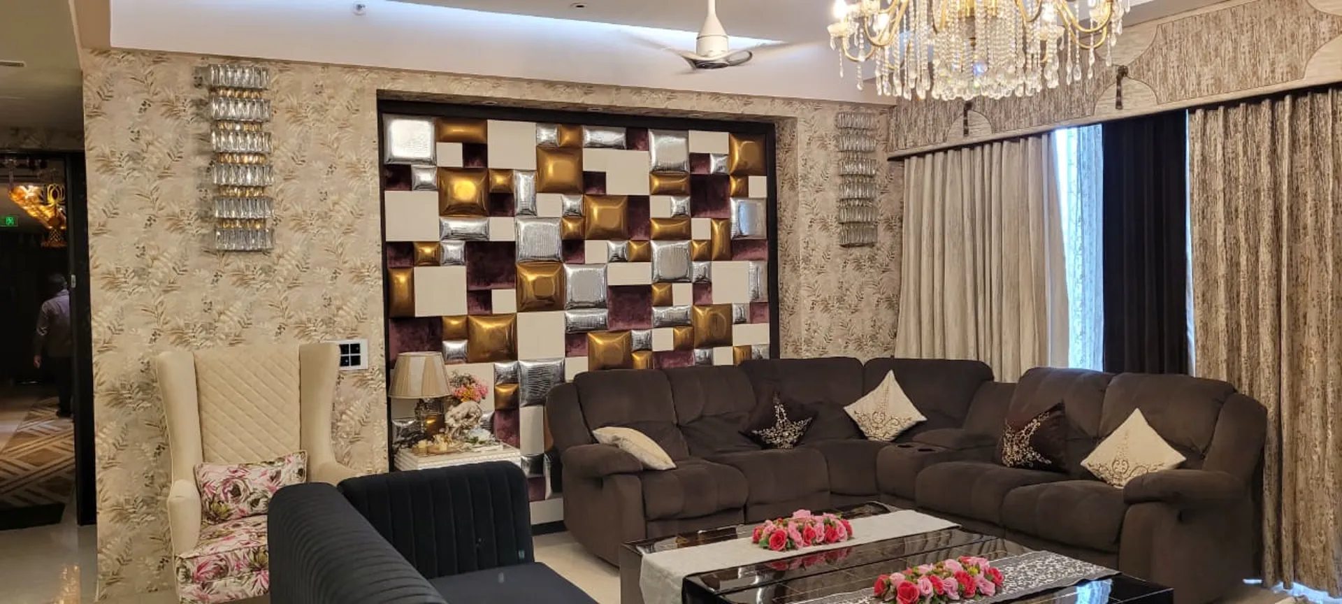 Living room with fluted brass and glitter-finish panel wall and sunburst wall clock